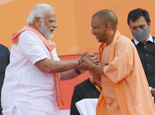 pm congratulates yogi adityanath on becoming cm