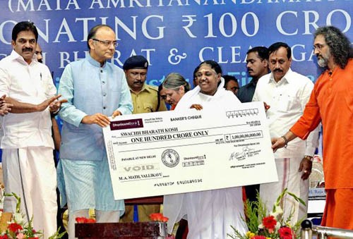 maa amrita handing over a cheque of finance minister arun jaitley