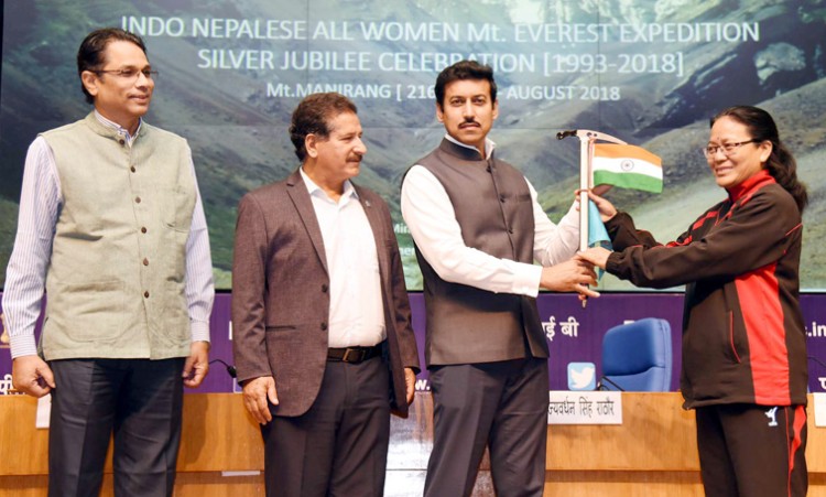 col. rajyavardhan singh rathore handing over the flags to bimla negi