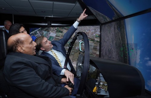 defense minister observing boeing mobile flight simulator