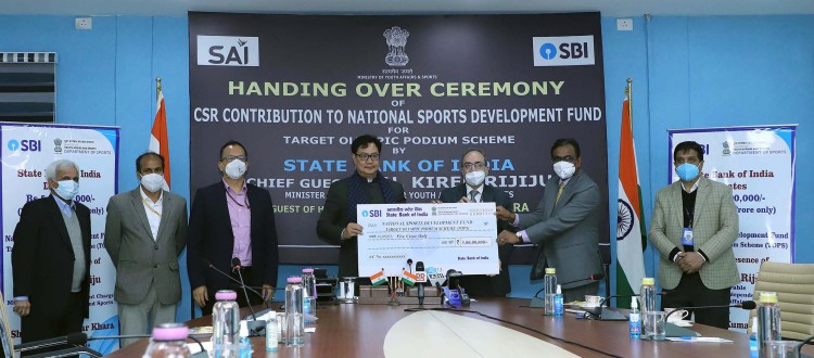 kiren rijiju receiving a cheque from the chairman state bank of india dinesh kumar khara