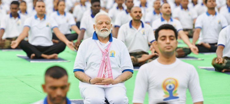 prime minister narendra modi while practicing yoga