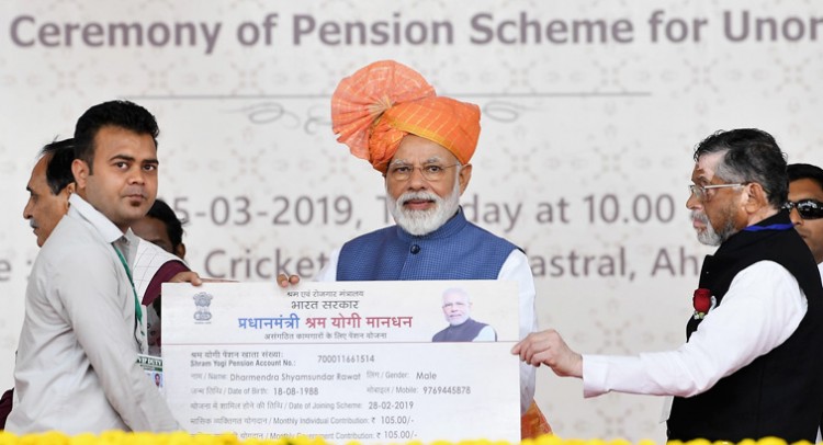 narendra modi distributing the pm-sym pension cards to select beneficiaries