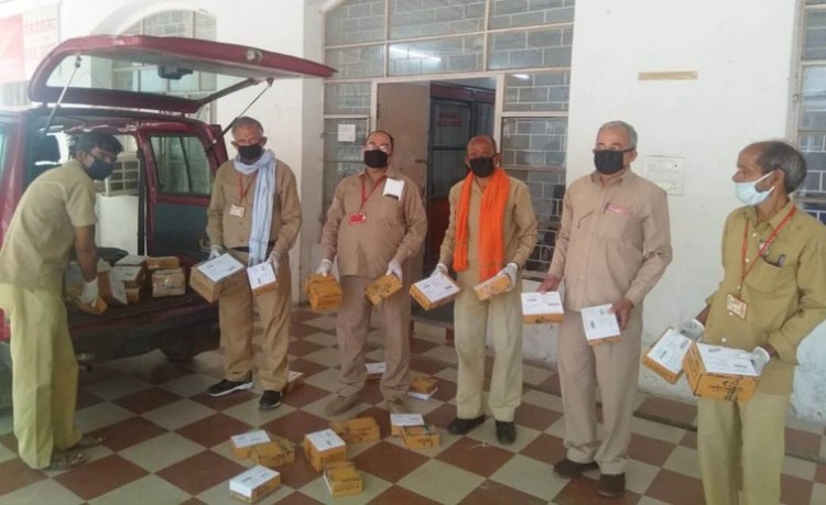 postman in lucknow gpo getting ready for delivery of medicine packets through mail van