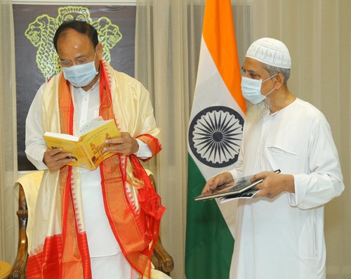 vice president receiving the book by journalist j.s. ifthekhar